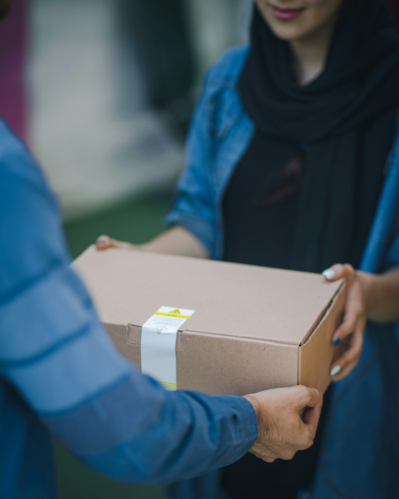 A parcel being handed over between two people